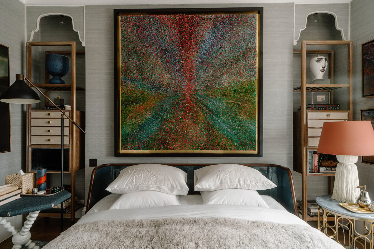 A Cozy Art-Filled Attic Apartment in London 17 bedroom with large art work above the bed