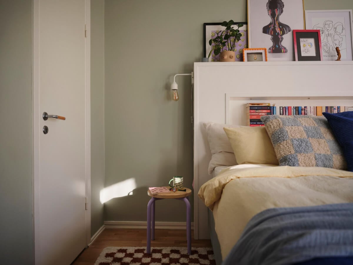 A Midcentury Swedish Apartment with Bright Color Accents 16 bedroom with storage headboard