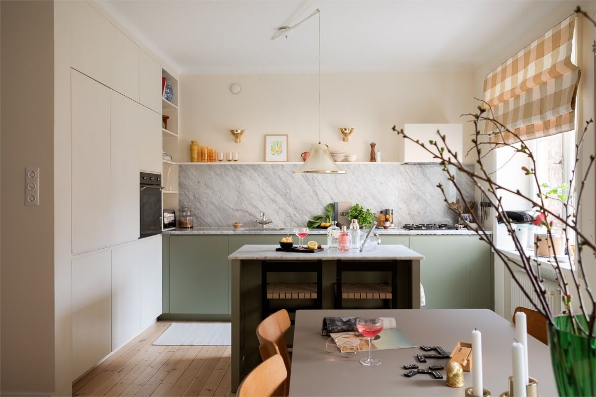 A Light-Filled Two Bedroom Apartment in Stockholm 4 beige and green kitchen marble countertop island