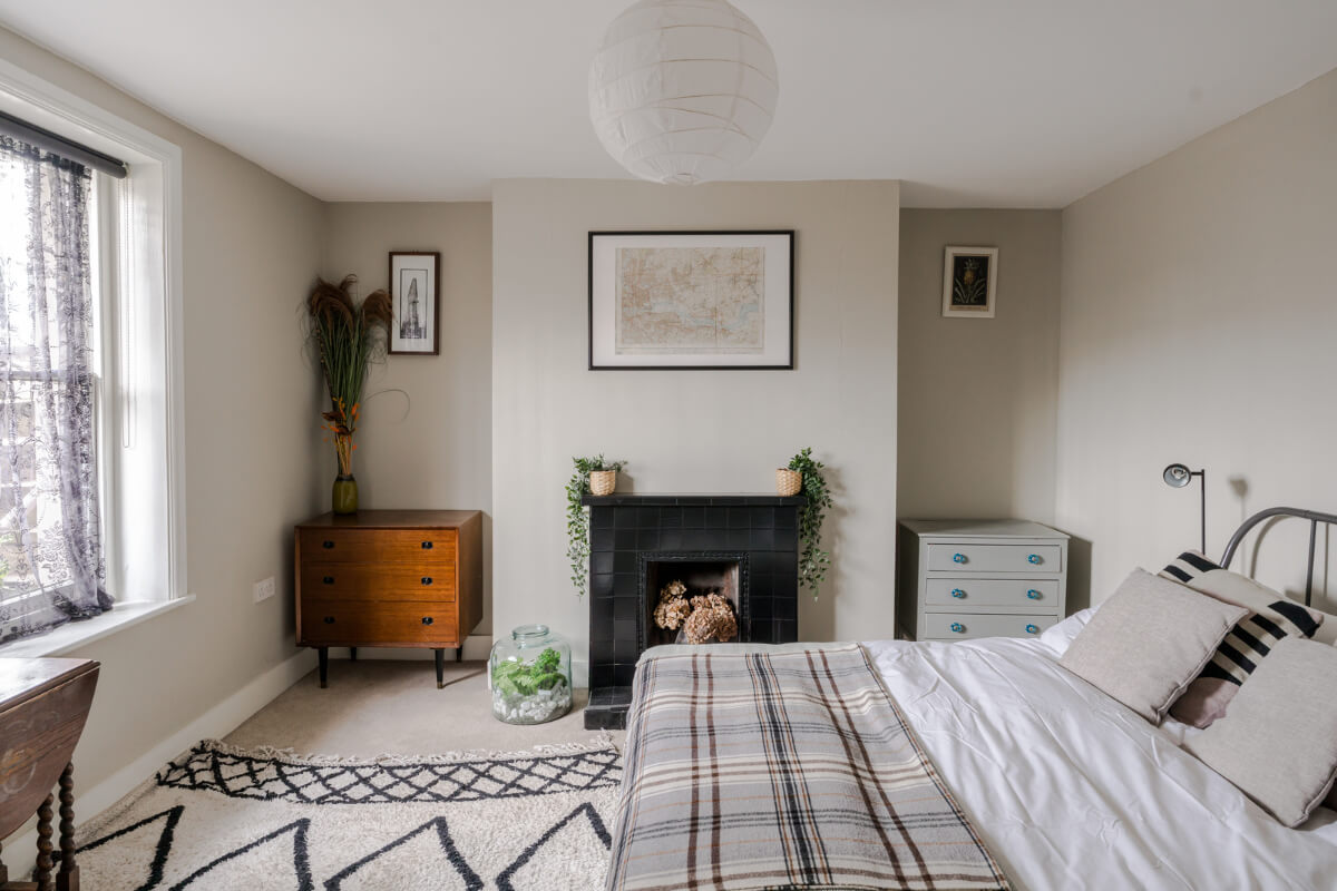 Timeworn Original Floorboards in a Regency Seaside Home 21 beige bedroom black fireplace