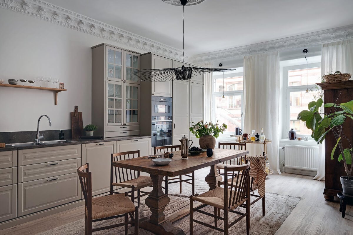Warm and Inviting Rooms in a Renovated Swedish Apartment 12 beige-kitchen-stucco-large-wooden-table
