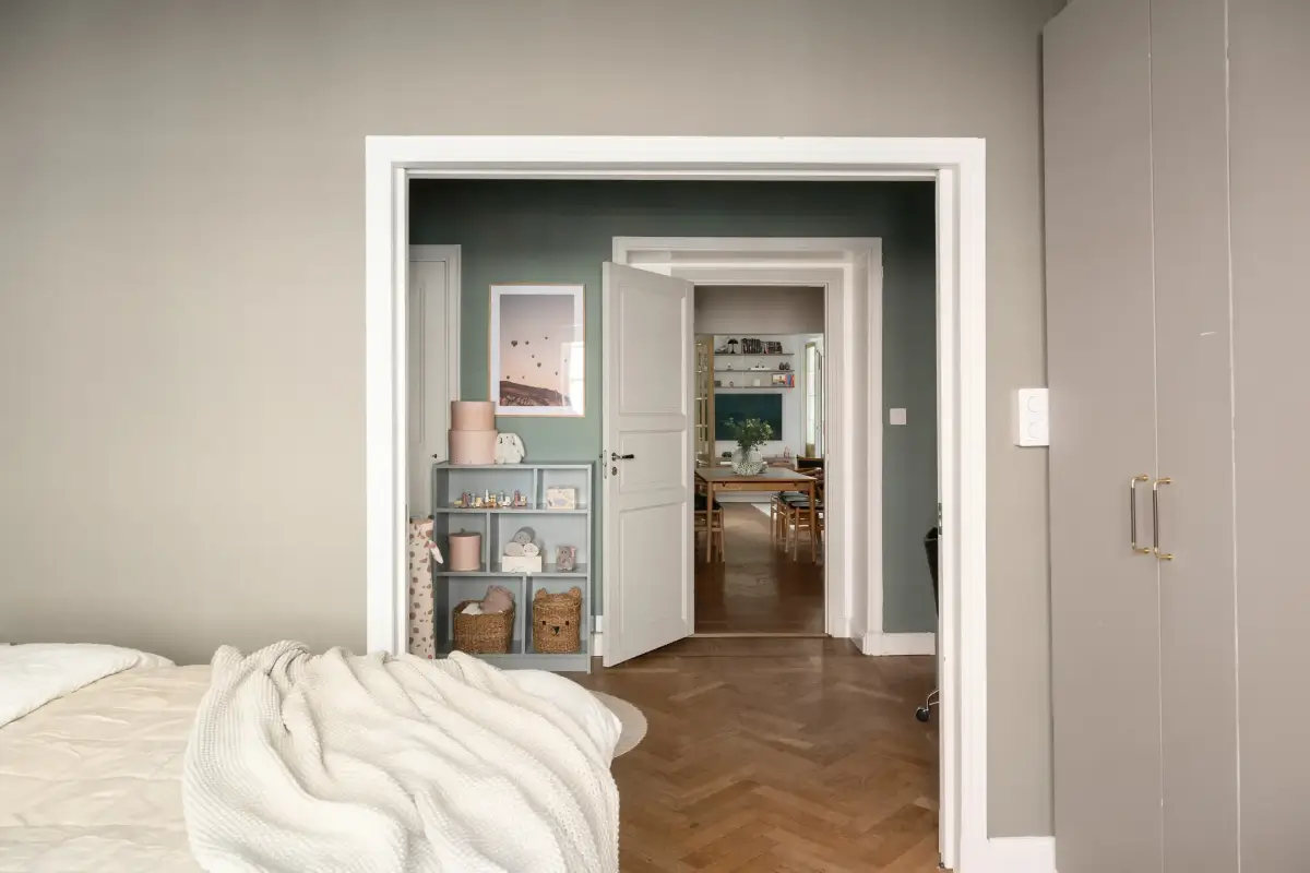 A Charming Ground Floor Family Apartment in Stockholm 17 beige master bedroom inner hall parquet floor