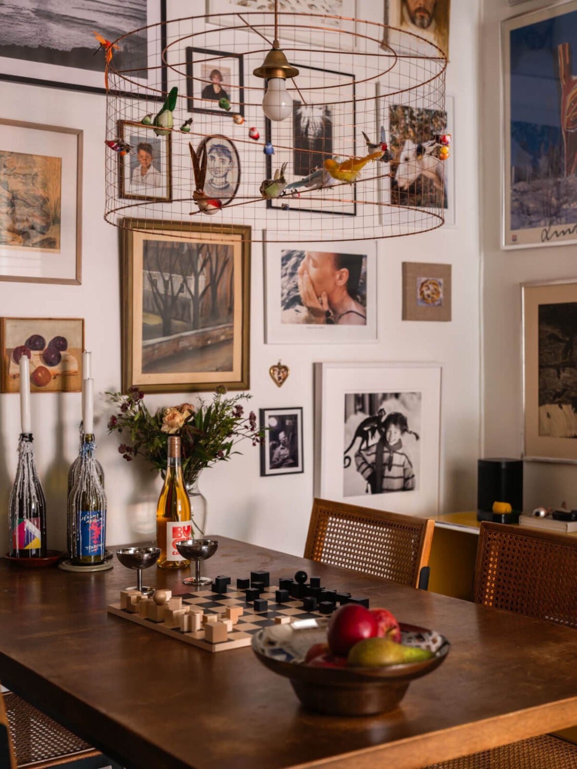 An Airy One-Bedroom Apartment with Art and A Yellow Kitchen 15 bird pendant light dining room with art