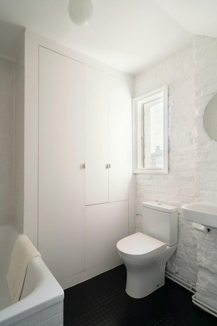 A Light One-Bedroom Apartment in a Victorian Terrace House 17 black and white bathroom exposed brick wall