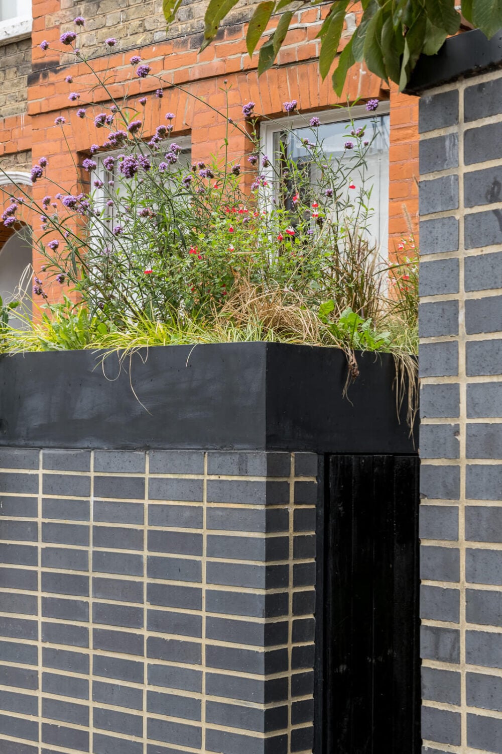 A Unique House in London with Plant-Filled Interiors and a Lush Garden 28 black bricks entry