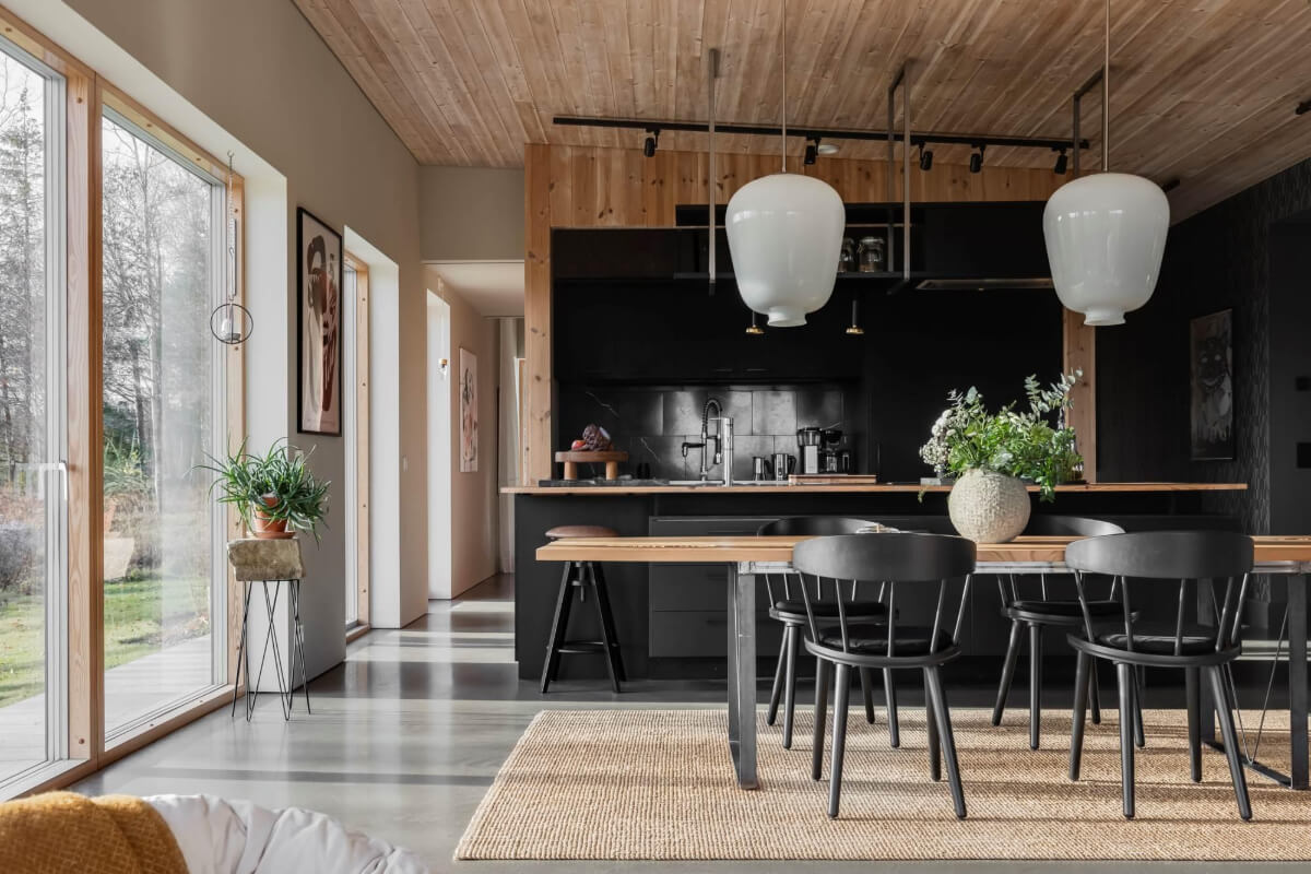 A Swedish Architectural Villa Surrounded by Nature 5 black kitchen and large dining table