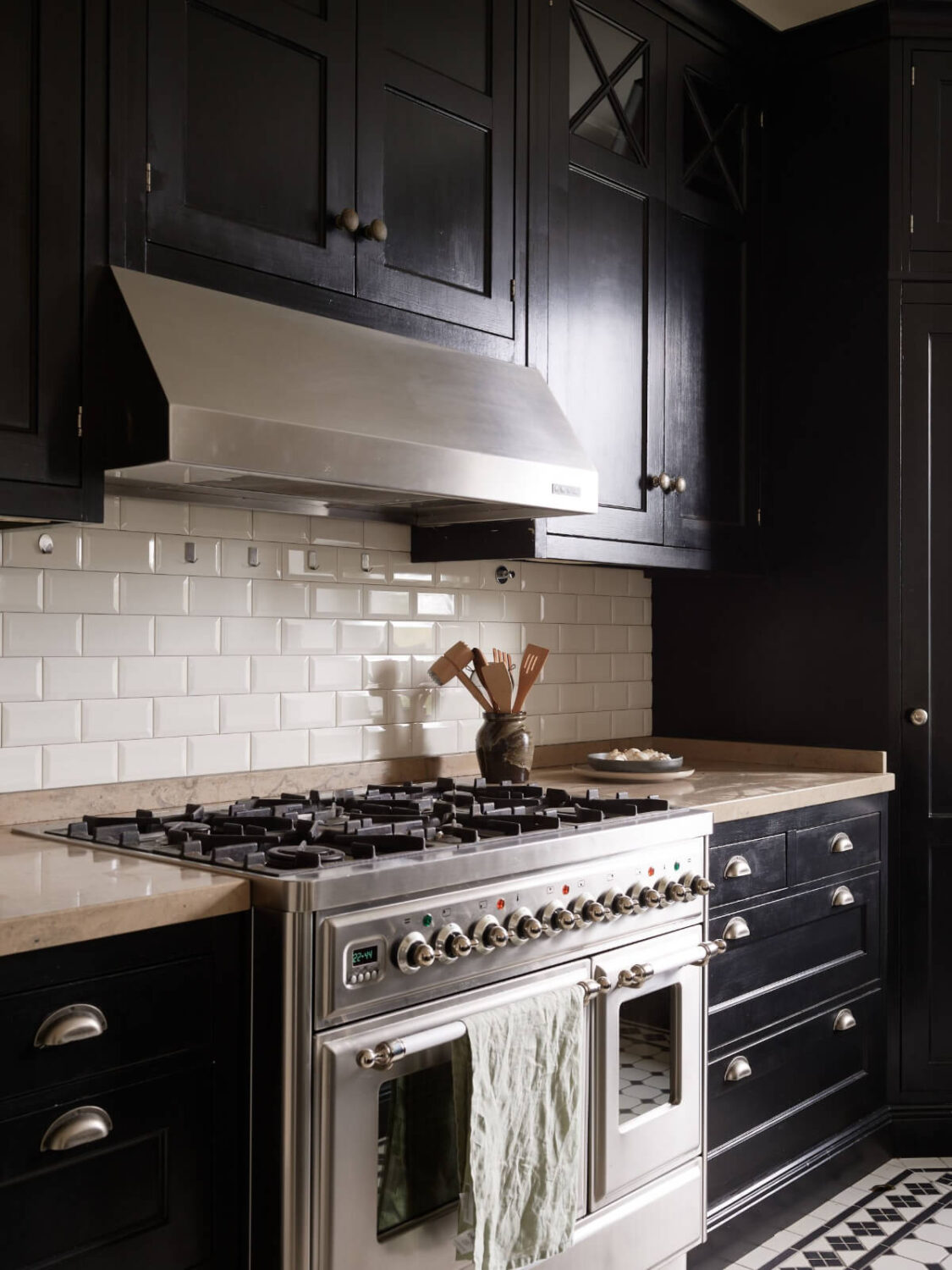 A Grand Early 20th-Century Apartment in Stockholm 7 black kitchen cabinets white backsplash tiles