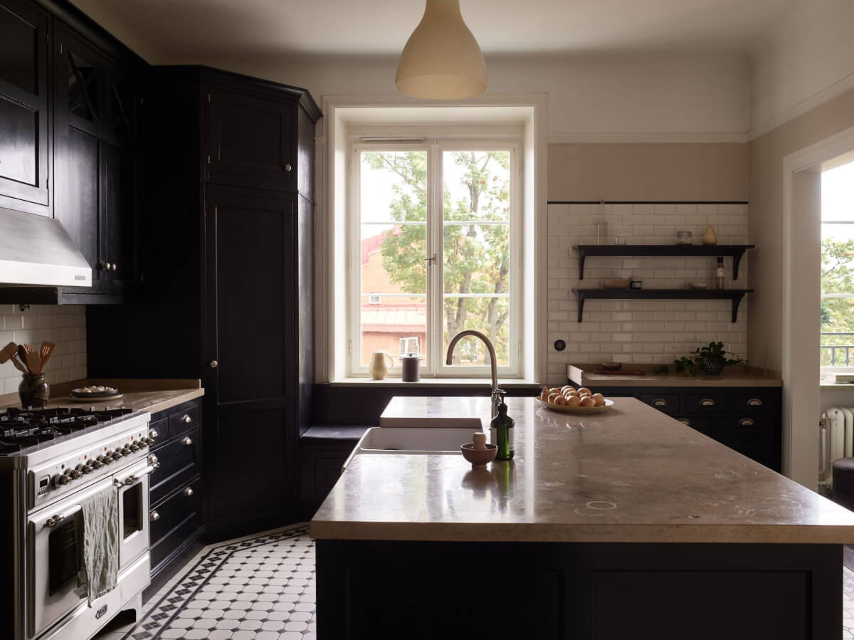 A Grand Early 20th-Century Apartment in Stockholm 8 black kitchen large island