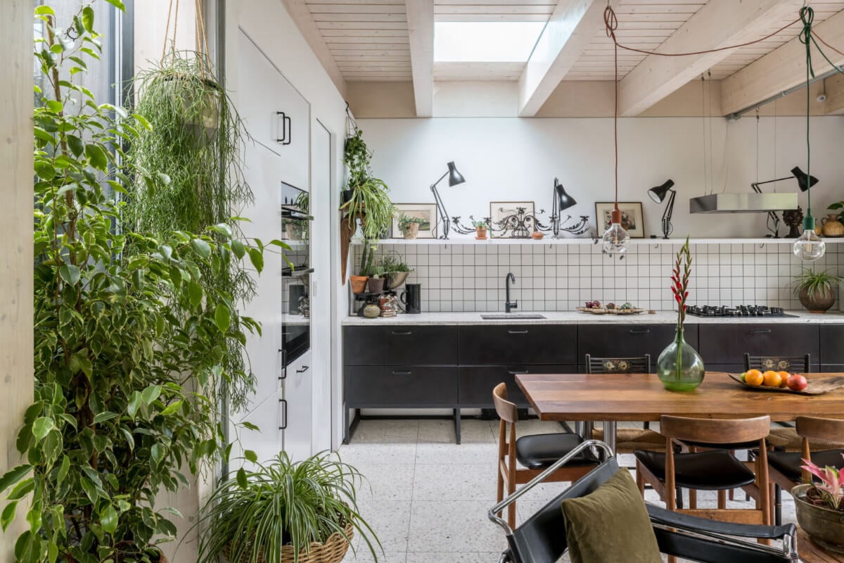 A Unique House in London with Plant-Filled Interiors and a Lush Garden 6 black kitchen white tiles