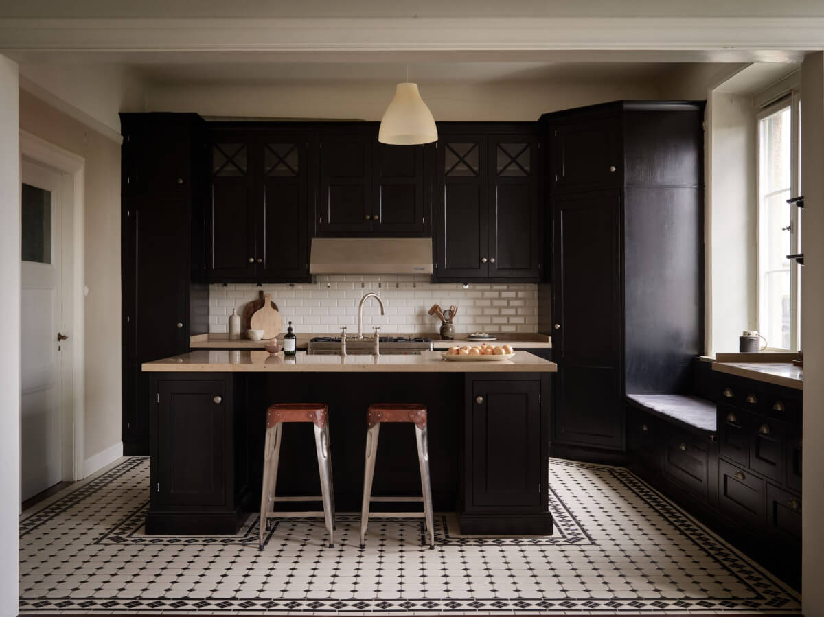 A Grand Early 20th-Century Apartment in Stockholm 5 black kitchen with island classic floor tiles