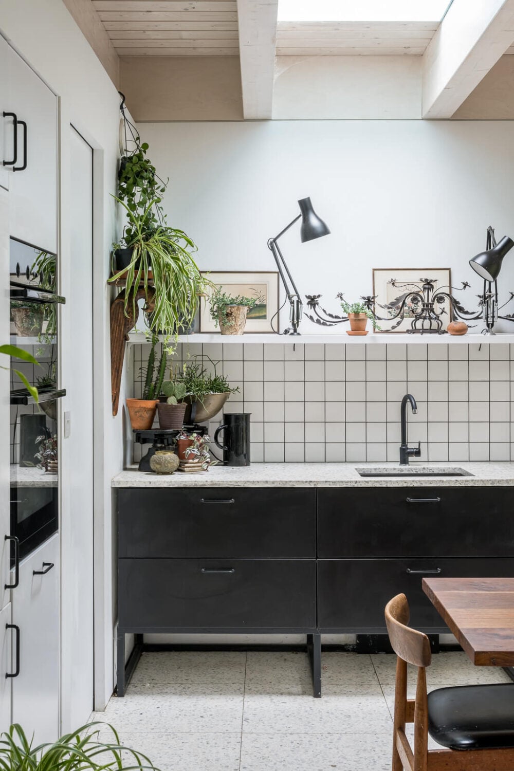 A Unique House in London with Plant-Filled Interiors and a Lush Garden 9 black white kitchen