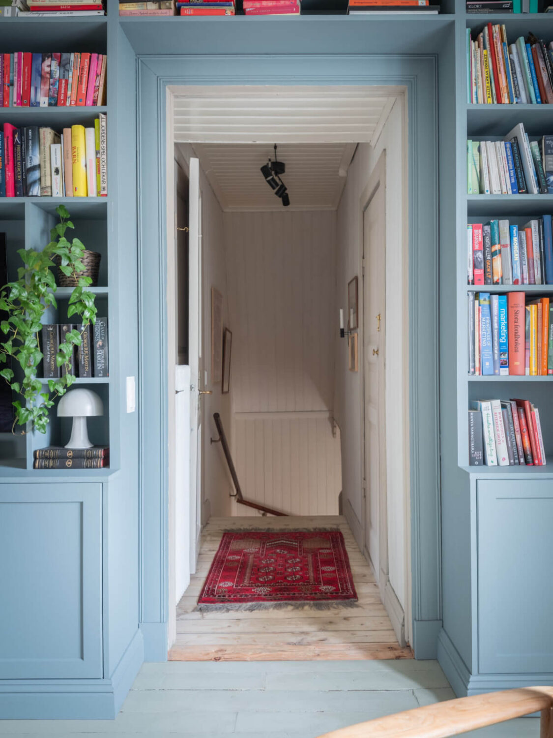 A Carefully Renovated Family Home in Sweden 6 blue fitted bookshelves
