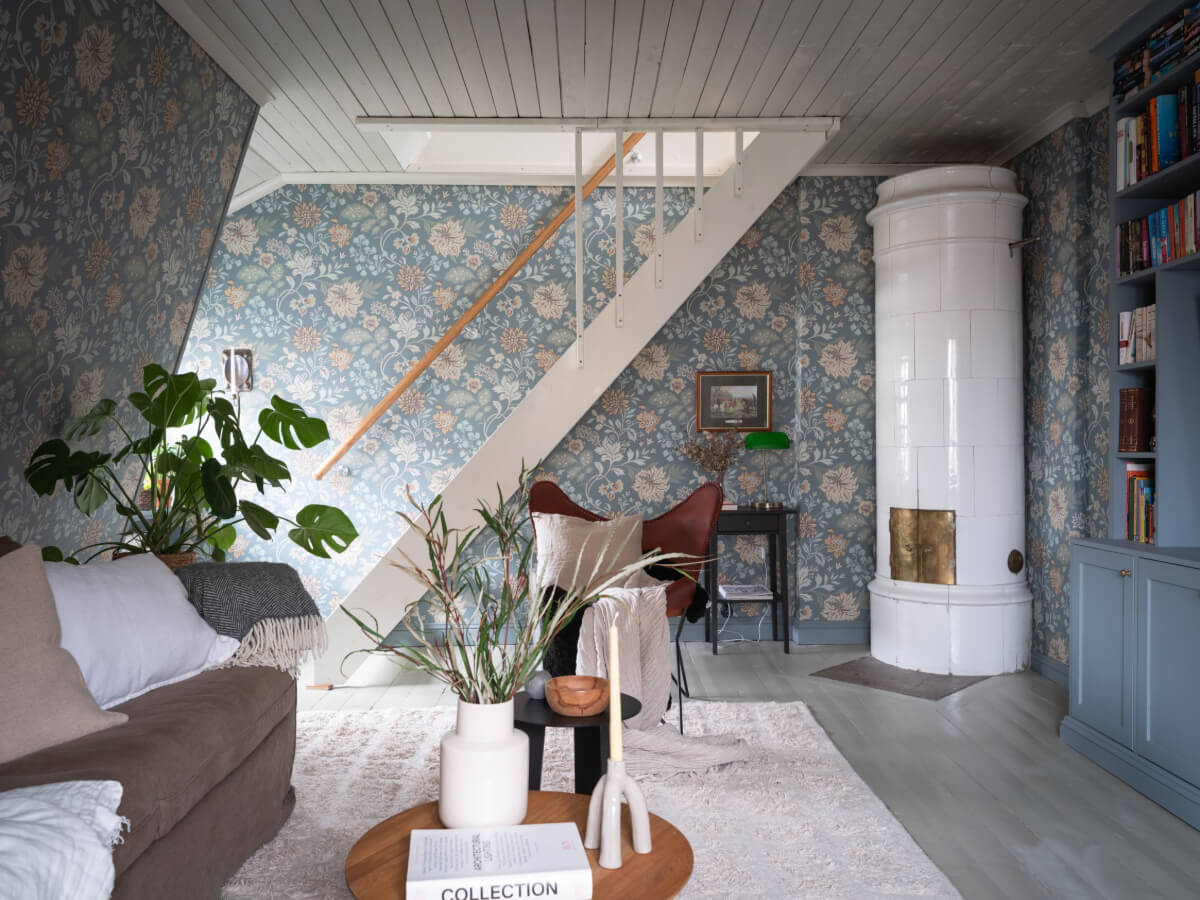 A Carefully Renovated Family Home in Sweden 3 blue floral wallpaper and fireplace in living room