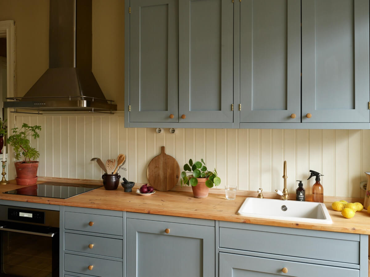 A Charming Historic Stockholm Apartment with a Blue Kitchen 4 blue kitchen brass knobs wooden countertop
