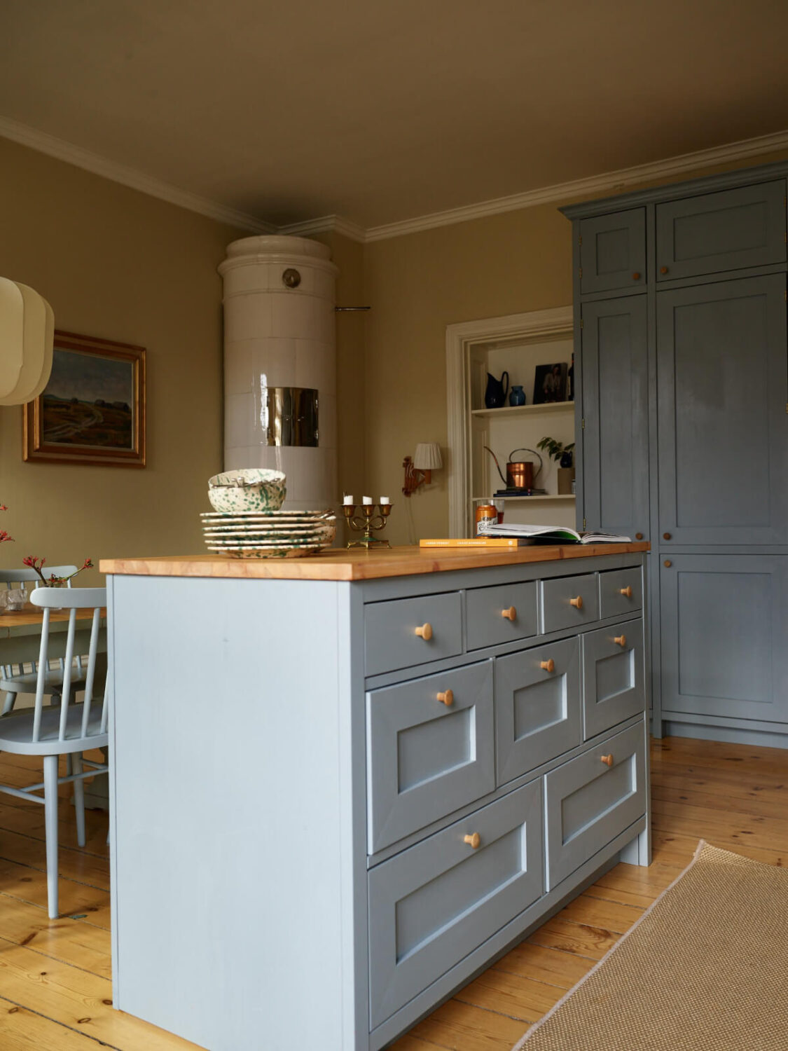 A Charming Historic Stockholm Apartment with a Blue Kitchen 5 blue kitchen island with drawers