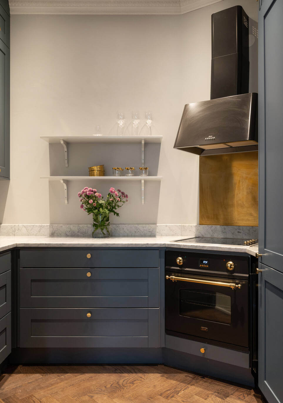 Beautiful Period Features in a One-Bedroom Stockholm Apartment 6 blue kitchen marble countertop brass fttings