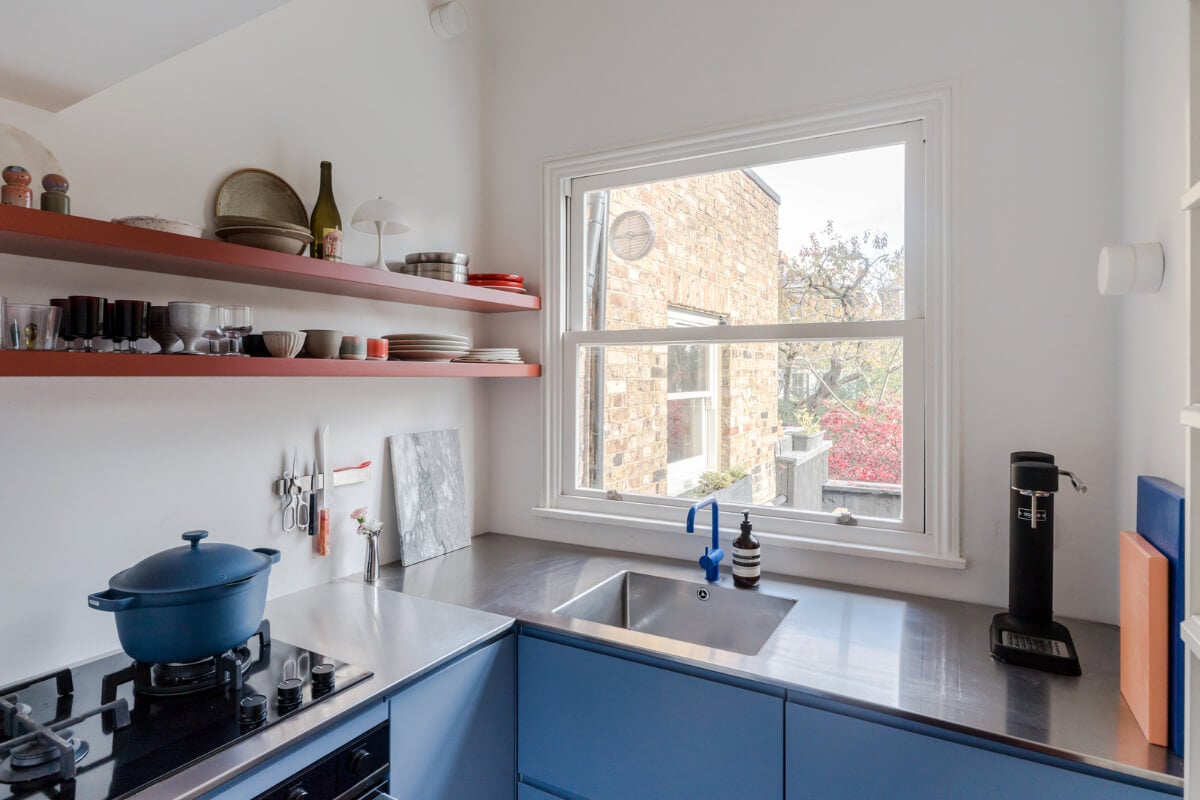 A Modern Apartment in a London Victorian House 11 blue kitchen with red shelves A Modern Apartment in a London Victorian House
