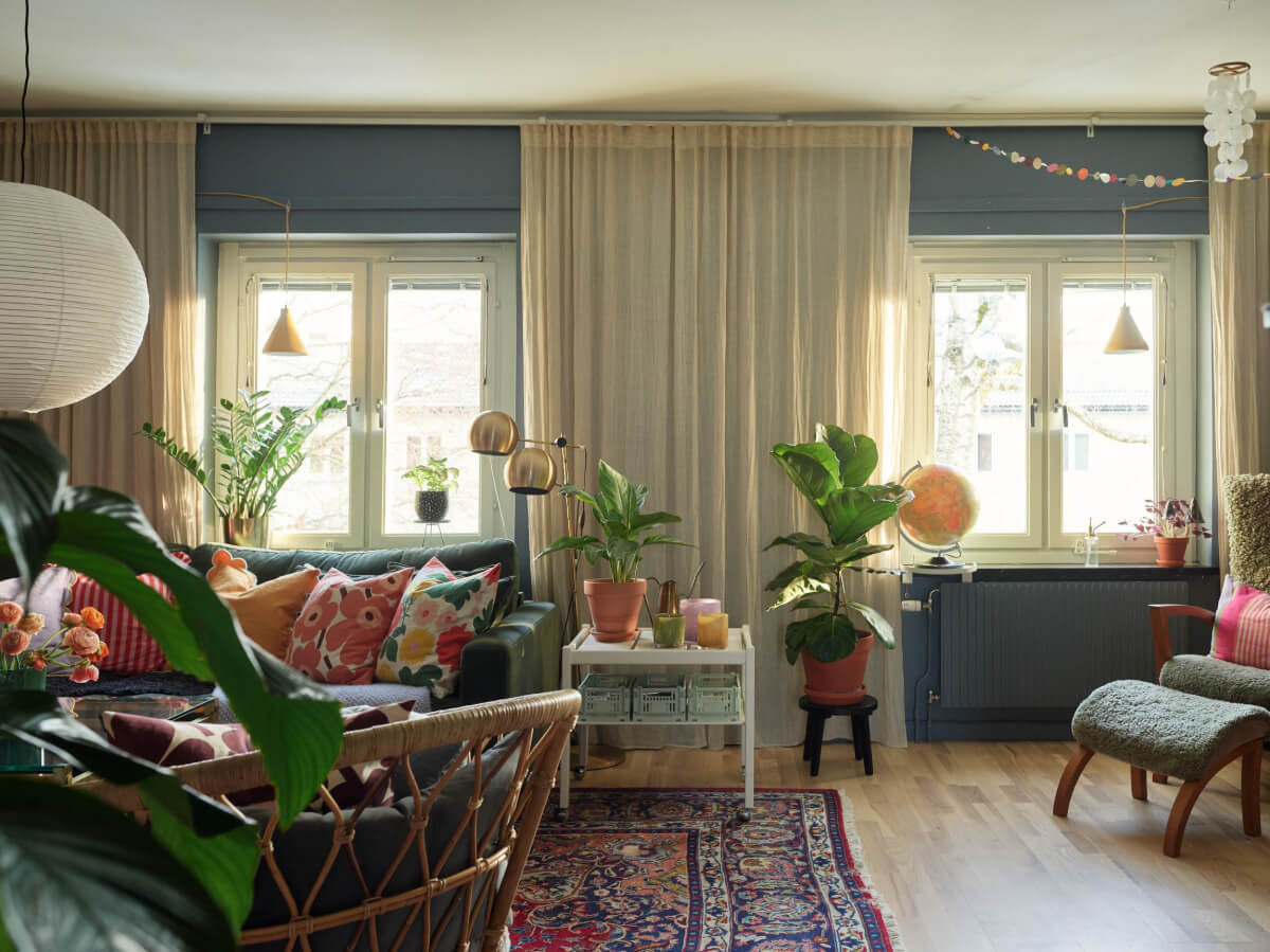A Colorful Midcentury Apartment Filled with Art and Plants 6 blue living room