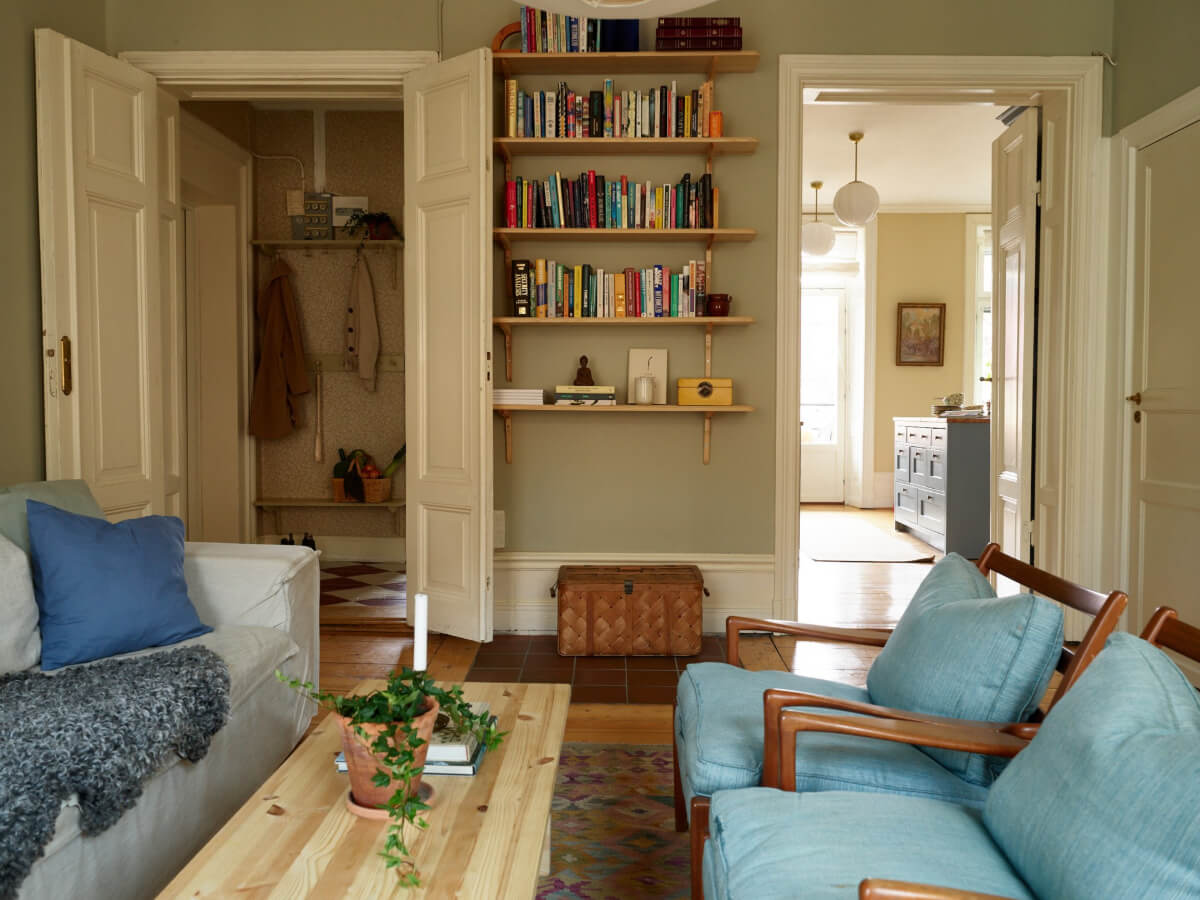 A Charming Historic Stockholm Apartment with a Blue Kitchen 20 bookshelves and original wooden doors