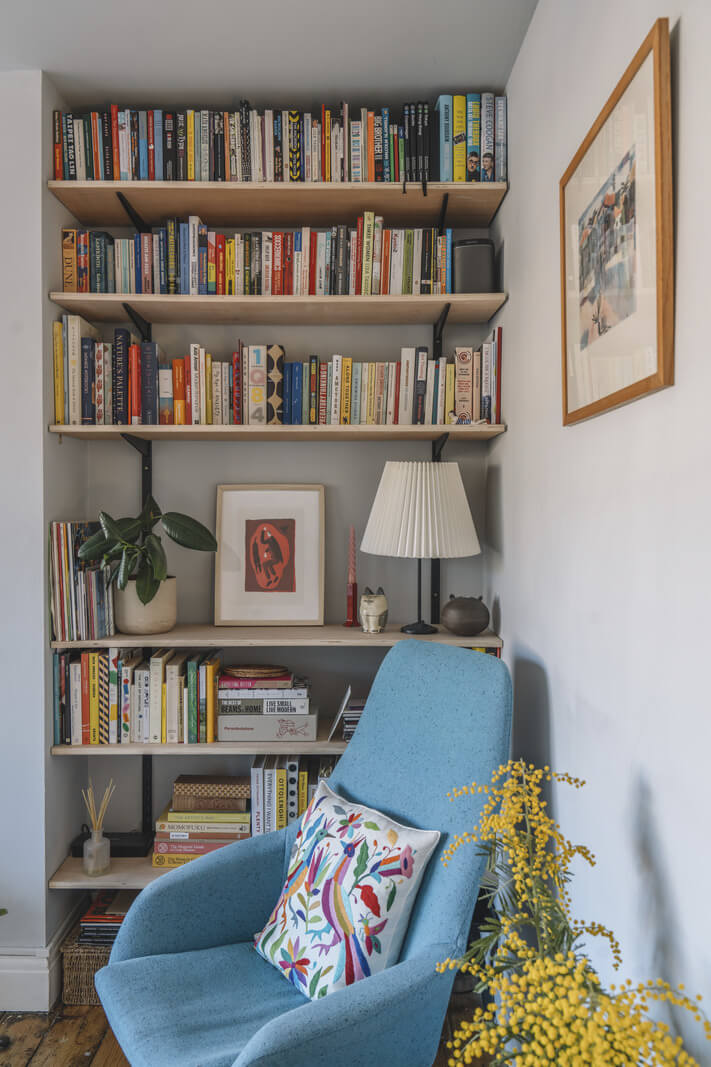A London Apartment with a Pink and Green Kitchen 3 bookshelves
