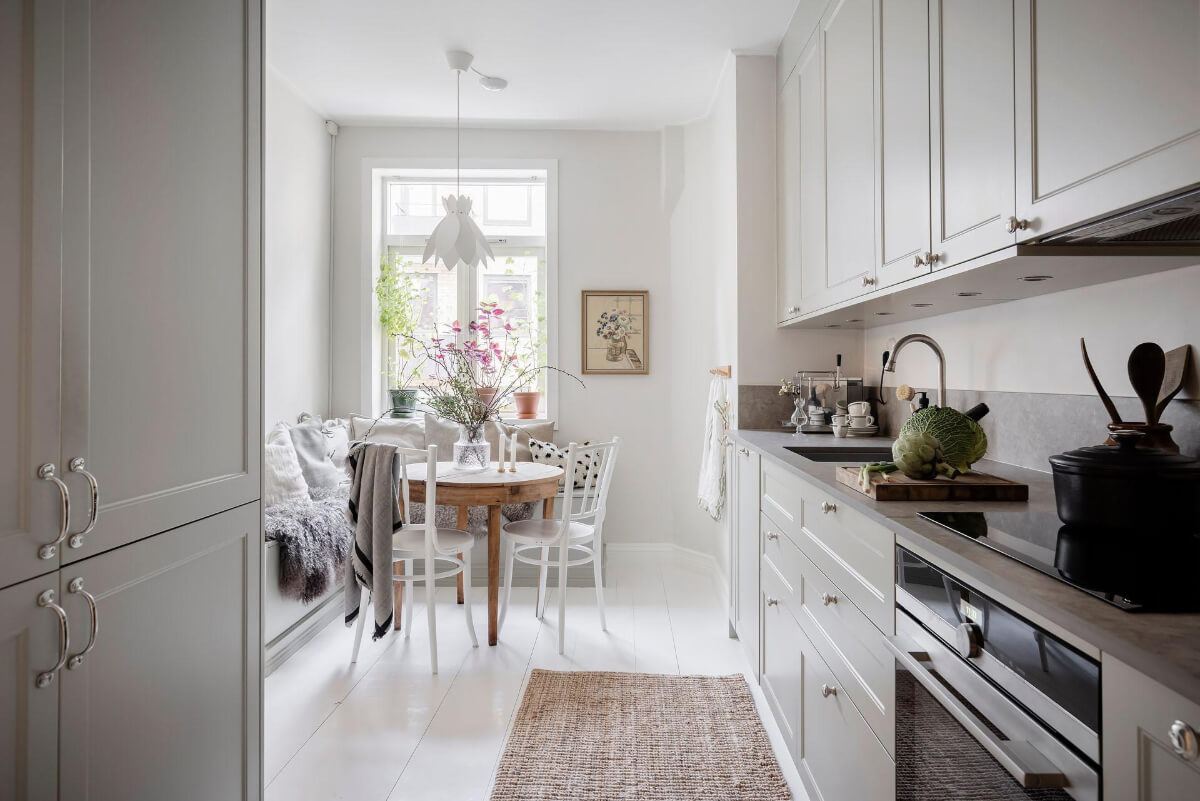 White-Painted Floorboards in a Turn-of-the-Century Apartment 10 bright kitchen white floorboards corner table with bench
