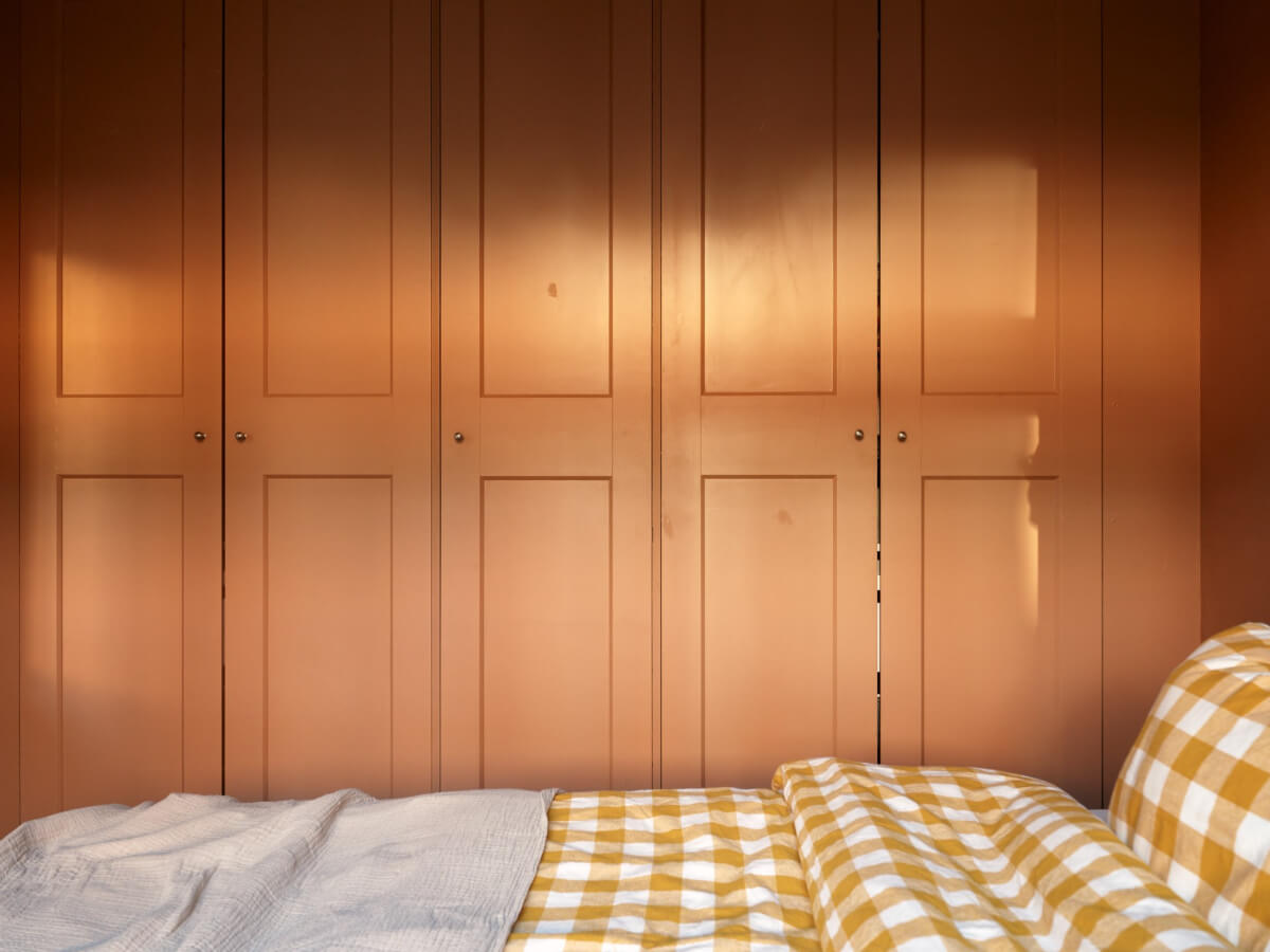 A Charming Historic Stockholm Apartment with a Blue Kitchen 24 built-in wardrobes yellow checkerboard duvet cover
