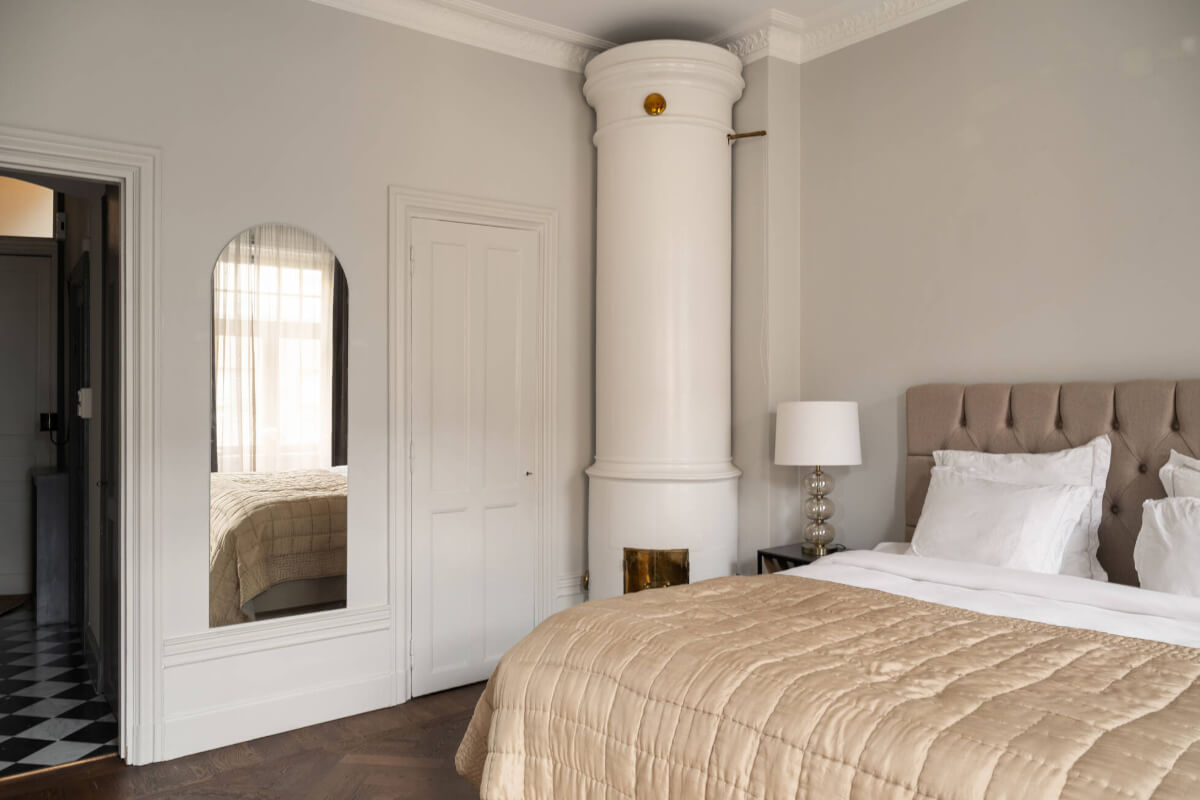 Beautiful Period Features in a One-Bedroom Stockholm Apartment 9 calm bedroom fireplace
