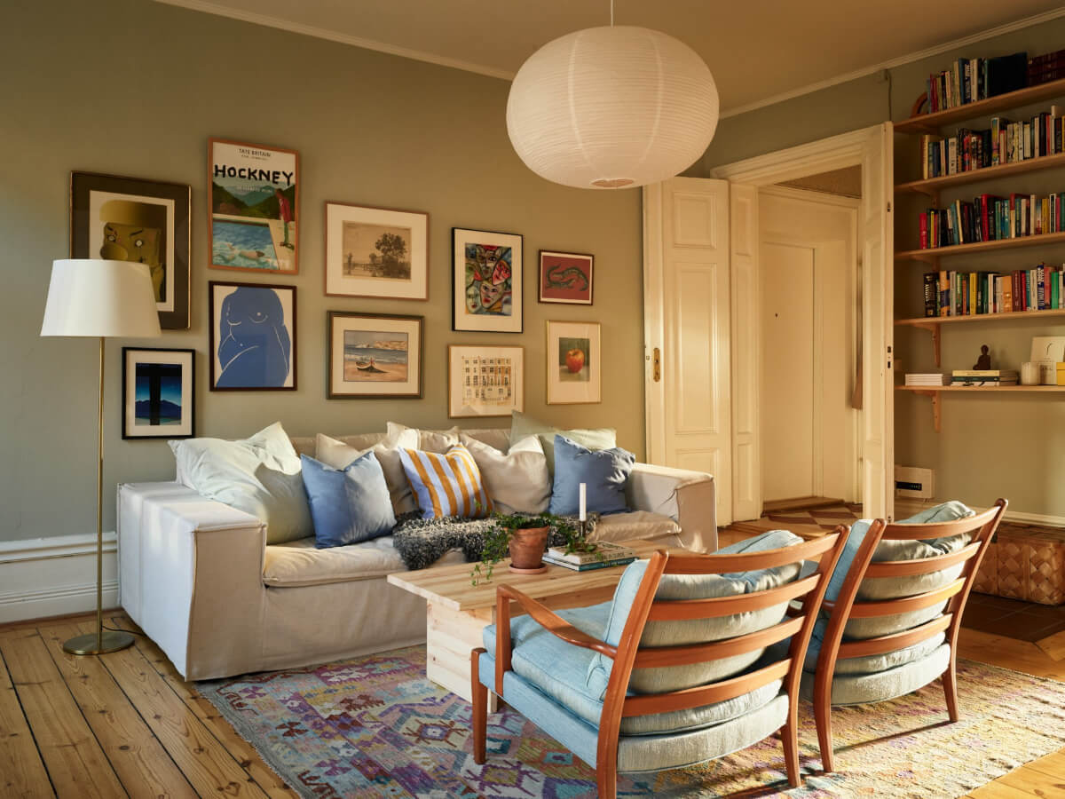 A Charming Historic Stockholm Apartment with a Blue Kitchen 17 calm living room gallery wall bookshelves