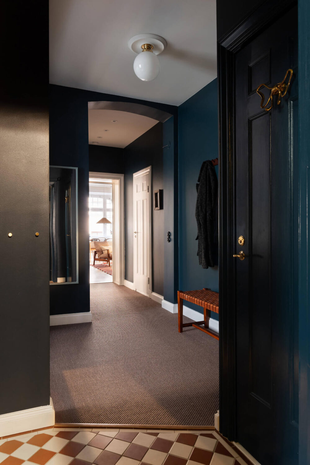 Contrasting Colors in a Turn-of-the-Century Apartment in Stockholm 24 checkerboard tile floor dark blue hall with carpet Contrasting Colors in a Turn-of-the-Century Apartment in Stockholm