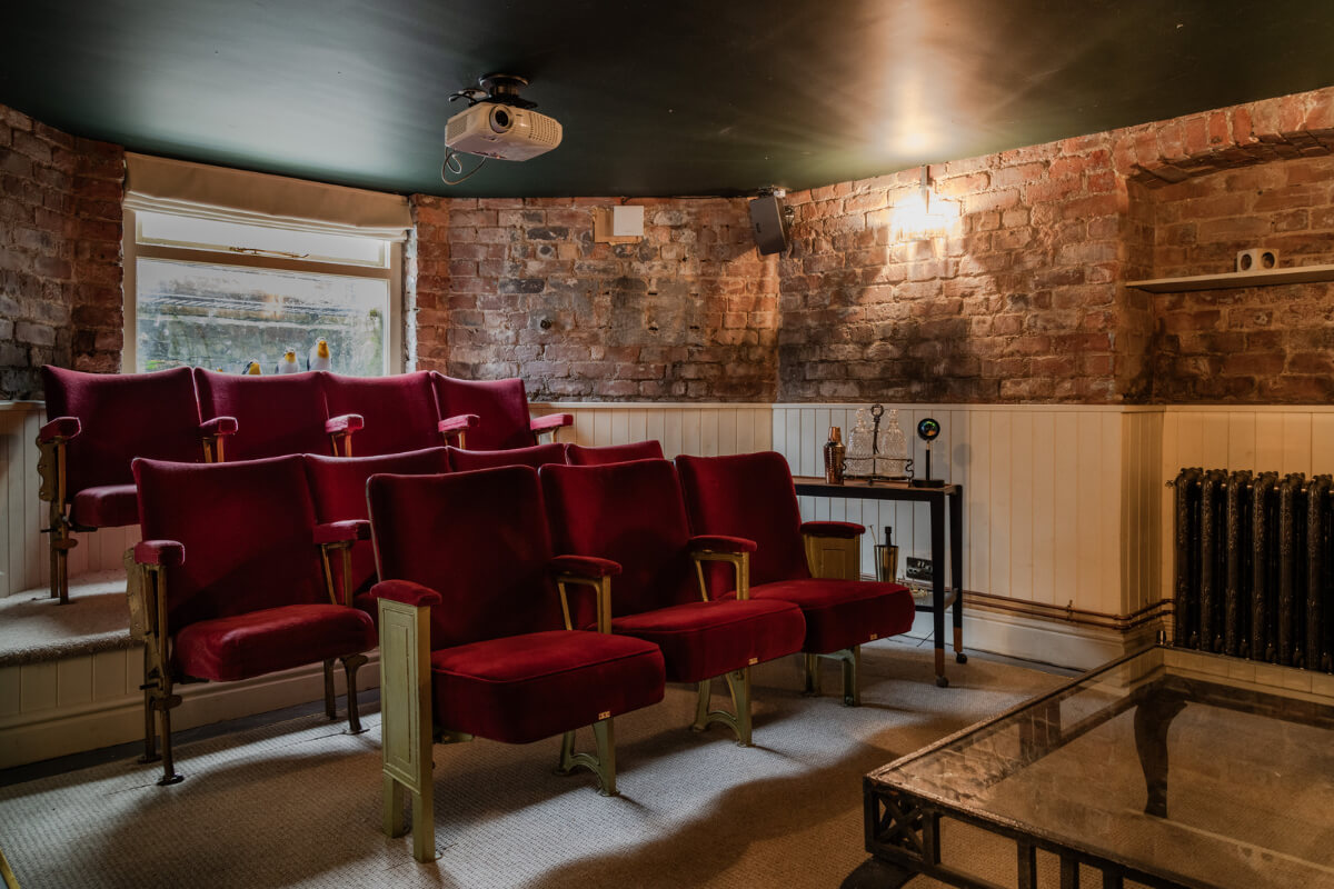 A Grand Victorian Villa in Manchester with Bold Interiors 31 cinema room black ceiling brick walls nordroom