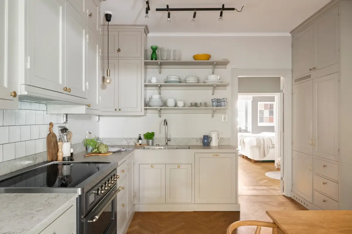 A Charming Ground Floor Family Apartment in Stockholm 3 classic beige kitchen brass knobs shelves