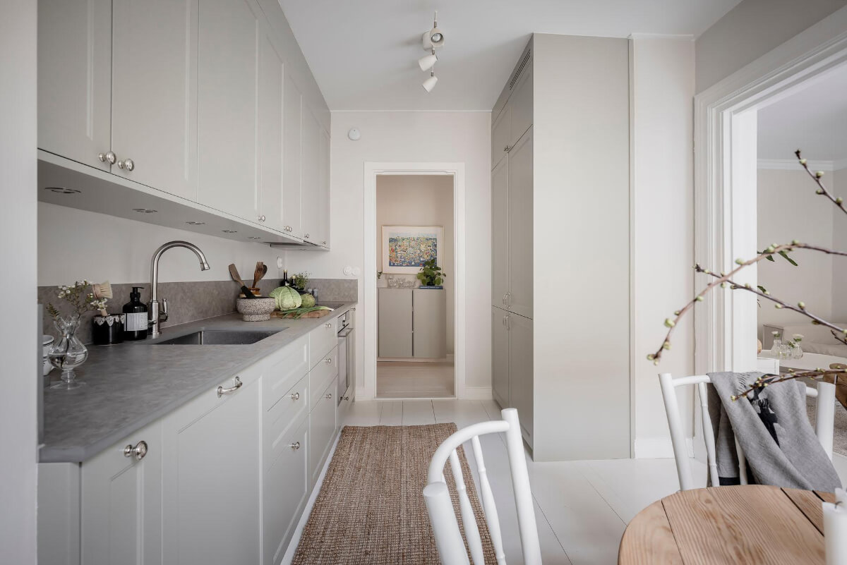 White-Painted Floorboards in a Turn-of-the-Century Apartment 18 classic light gray kitchen