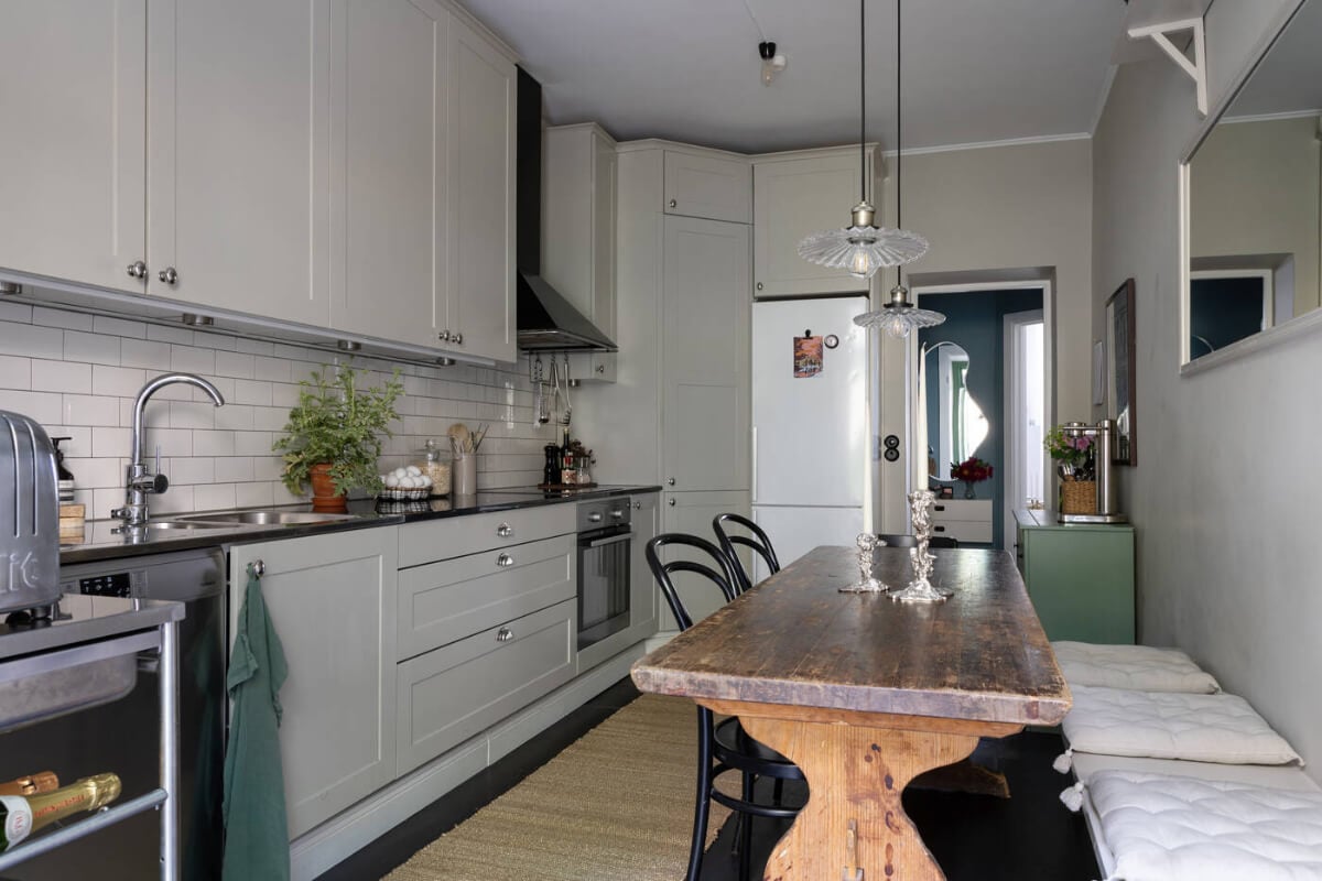 A Charming Ground Floor Apartment with a Large Patio Garden 11 classic light gray kitchen cabinets rustic dining table