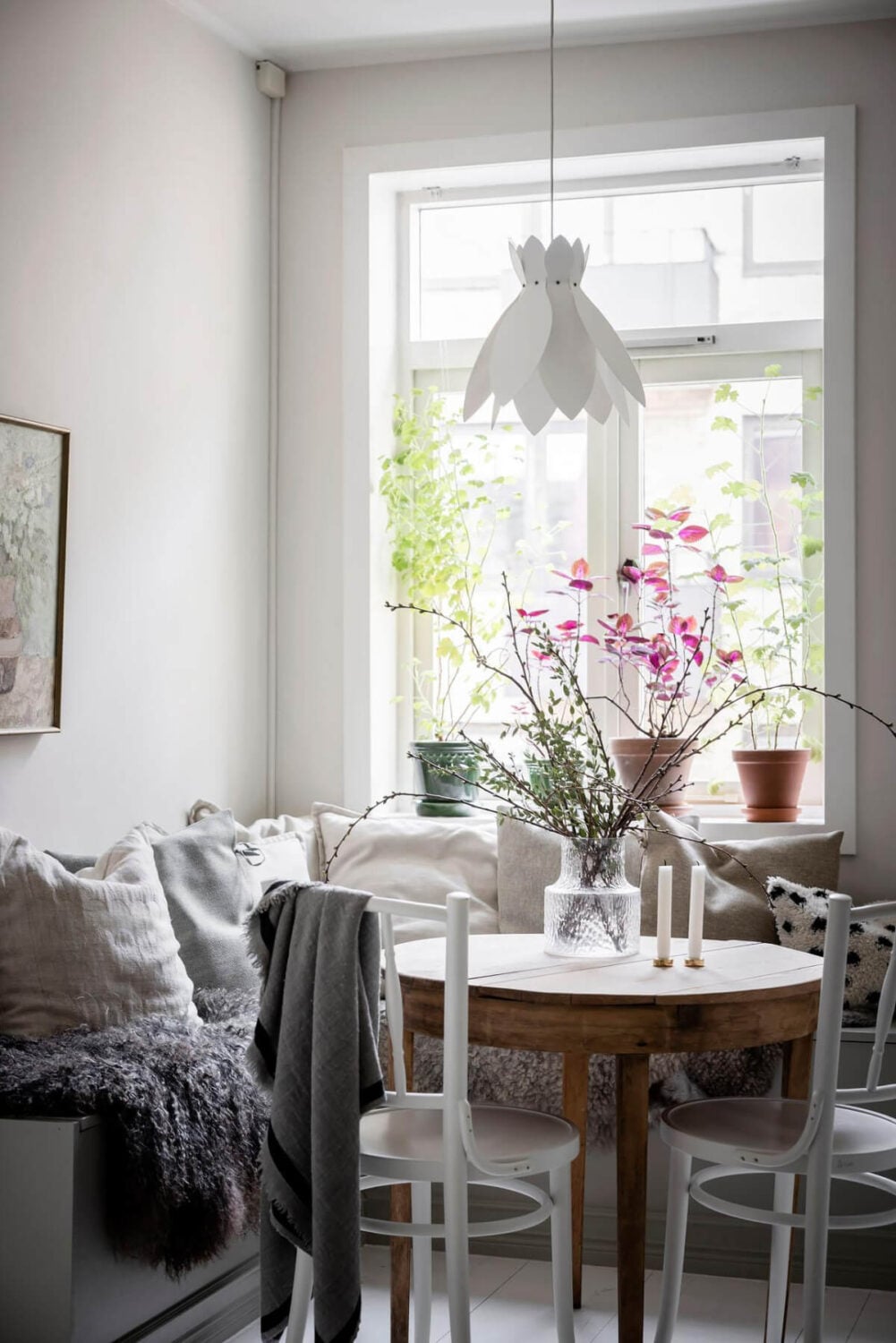 White-Painted Floorboards in a Turn-of-the-Century Apartment 17 cozy breakfast nook layered textiles round wooden table