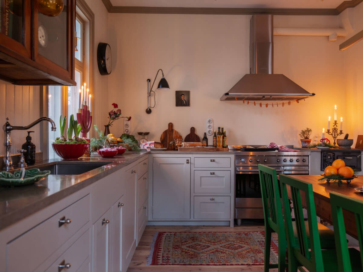 Trend Alert: The 'Soft Kitchen' is 2026's Coziest Interior Trend and It's Here to Stay 11 cozy kitchen with table and green chairs