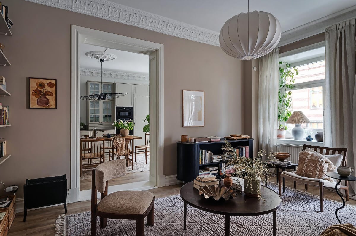 Warm and Inviting Rooms in a Renovated Swedish Apartment 6 cozy lviving room large rug warm wall color