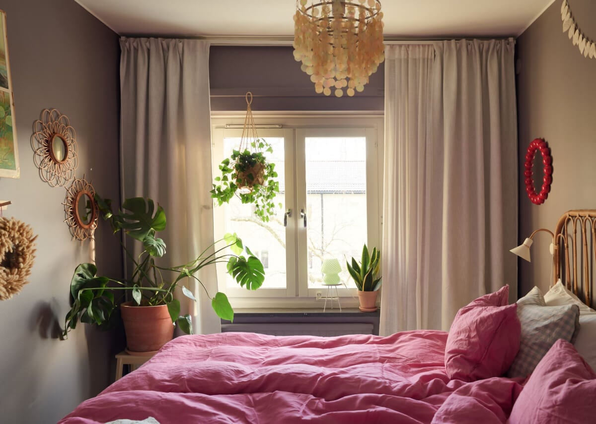A Colorful Midcentury Apartment Filled with Art and Plants 16 cozy plum colored bedroom