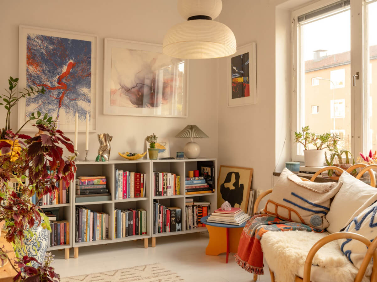A Charming Midcentury Apartment with a Reading Room 21 cozy reading room with rattan bench