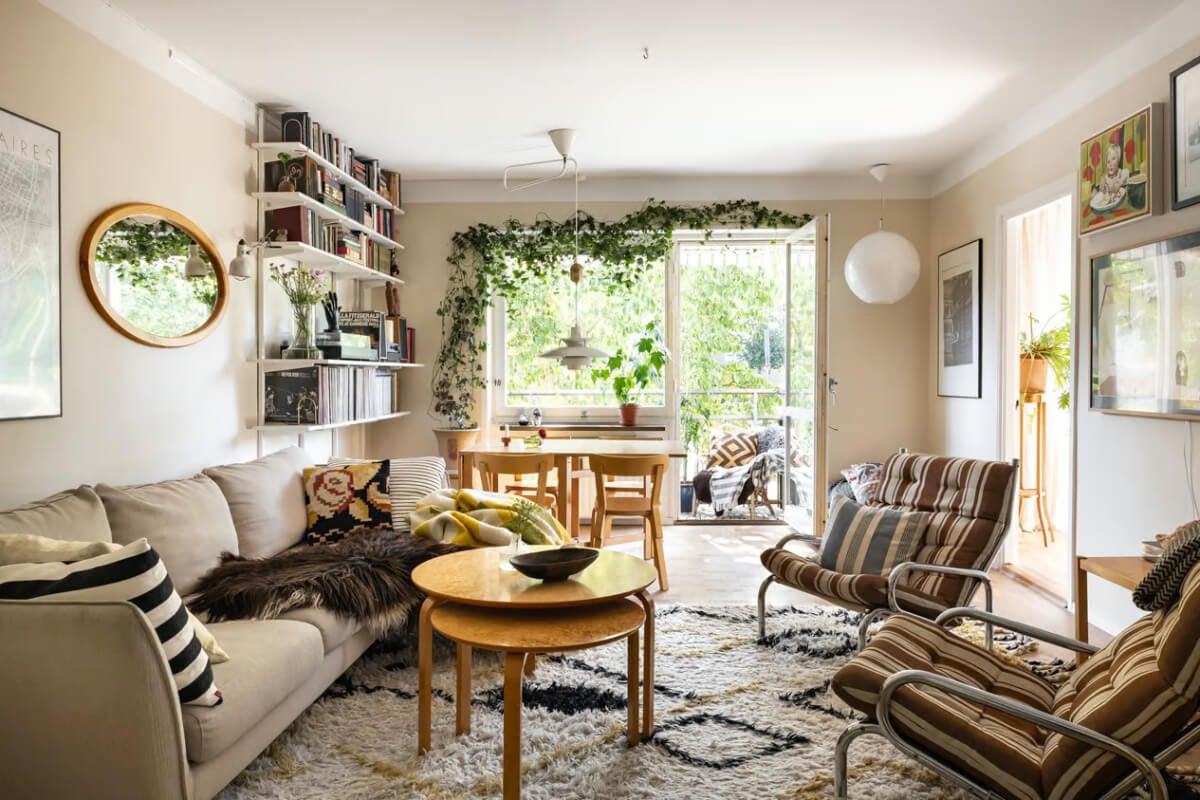 A Cozy Swedish Apartment in a 1950s Building 1 cozy scandi living room beige walls bookshelves balcony