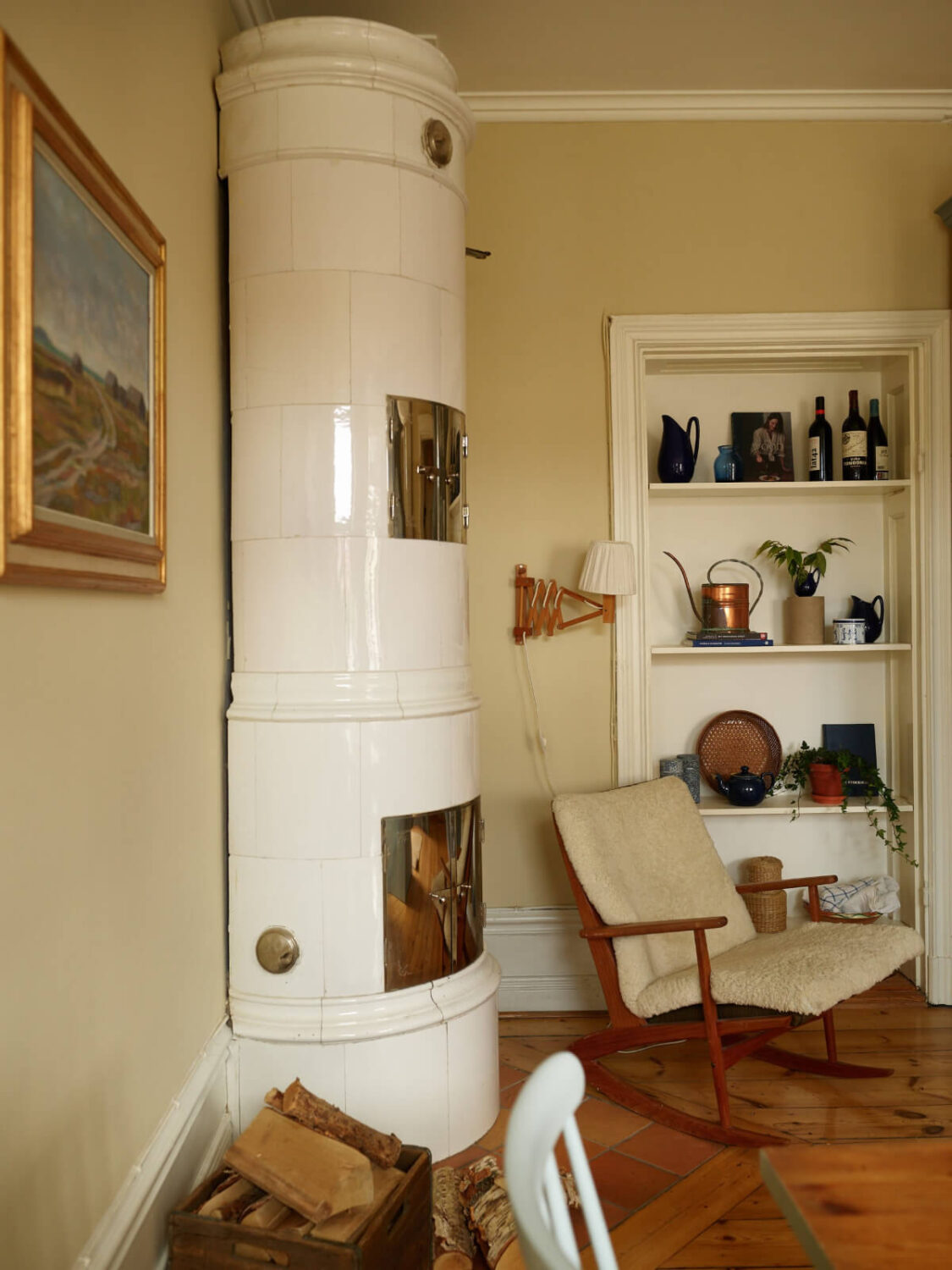 A Charming Historic Stockholm Apartment with a Blue Kitchen 13 cozy sitting nook fireplace bookshelves