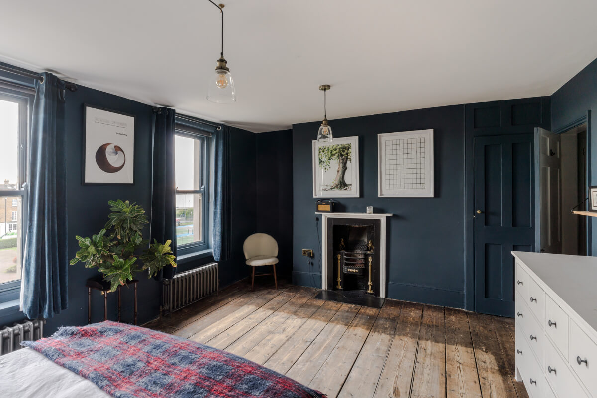 Timeworn Original Floorboards in a Regency Seaside Home 15 dark blue bedroom with fireplace