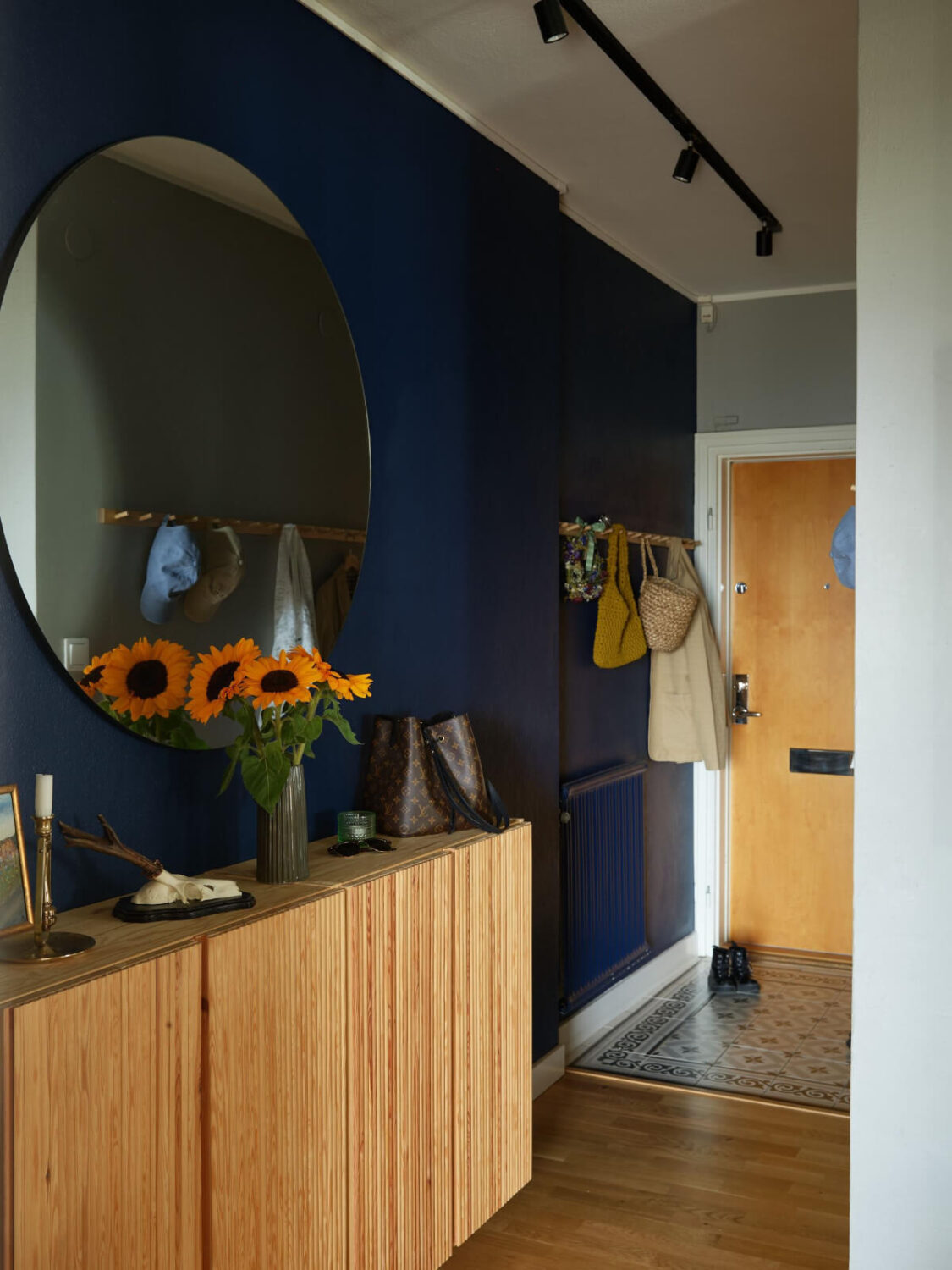 A Charming Two-Bedroom Corner Apartment in a 1940s Building 24 dark blue hall round mirror