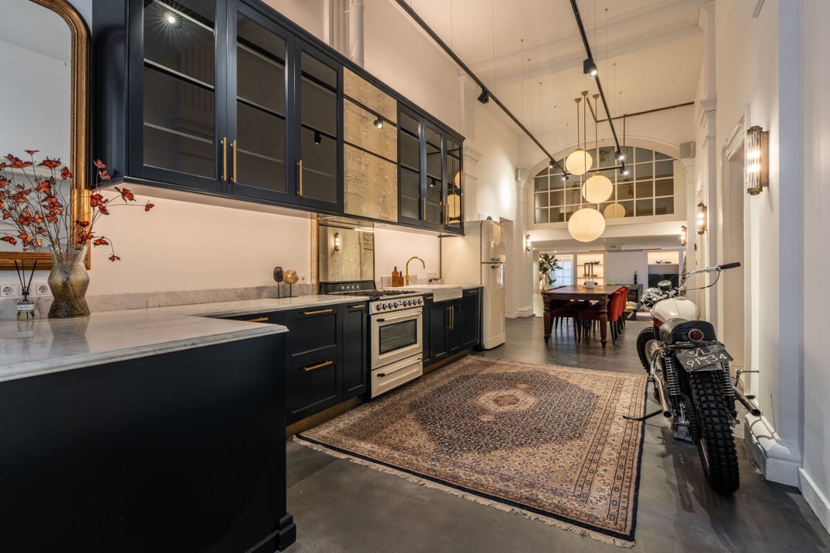 A Unique Ground Floor Duplex Apartment in Amsterdam 2 dark blue kitchen concrete floor amsterdam house