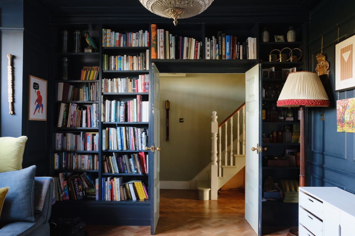 A London Edwardian House with a Light-Filled Kitchen Extension 17 dark blue living room bookshelves around doorframe