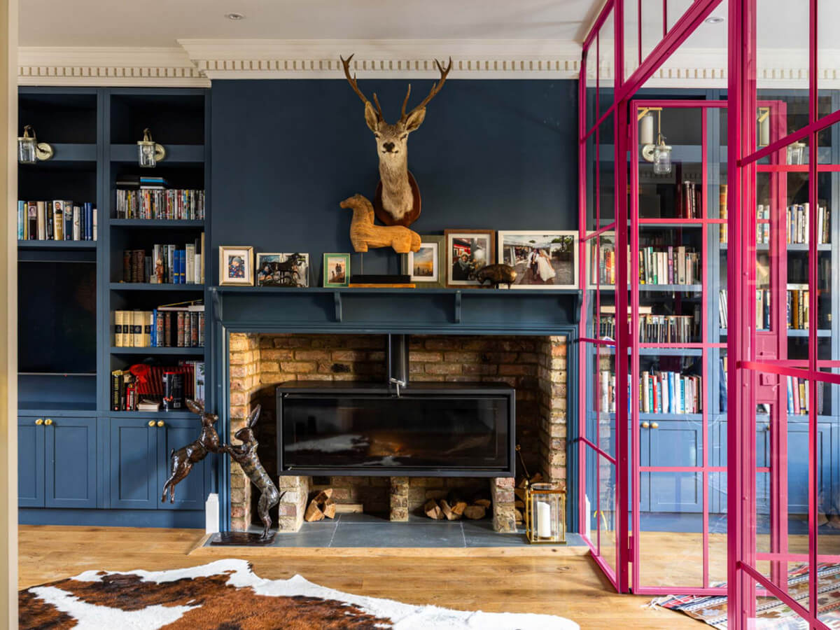 An Extended Family Home in London with Pink Crittall Doors 3 dark blue living room fireplace pink glass doors