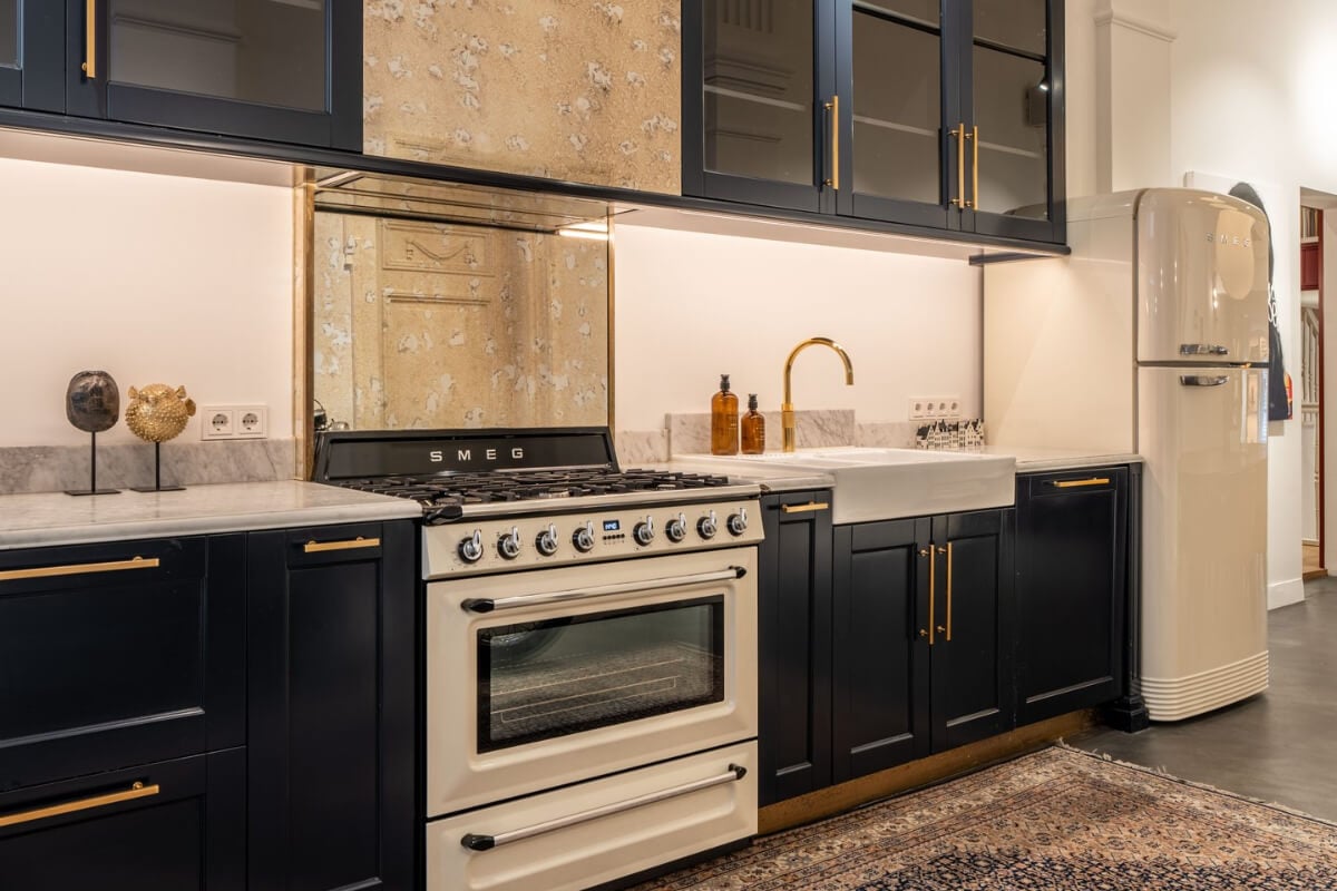 A Unique Ground Floor Duplex Apartment in Amsterdam 4 dark kitchen brass fittings smeg stove