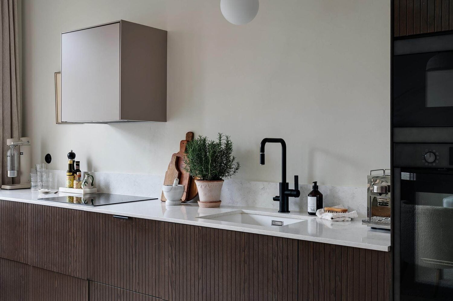 Period Features and Modern Materials in a Swedish Apartment 15 dark stained ash veneer kitchen marble countertop black tap