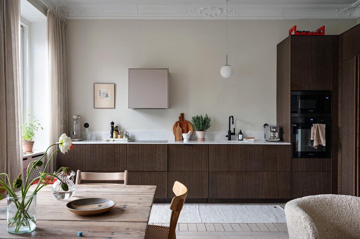 Period Features and Modern Materials in a Swedish Apartment 12 dark wood kitchen cabinet