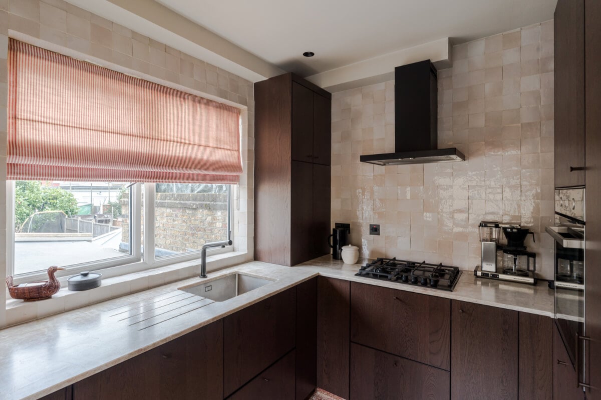 Cozy Contemporary Spaces in a Light-Filled Victorian Apartment 15 dark wwooden kitchen marble countertop