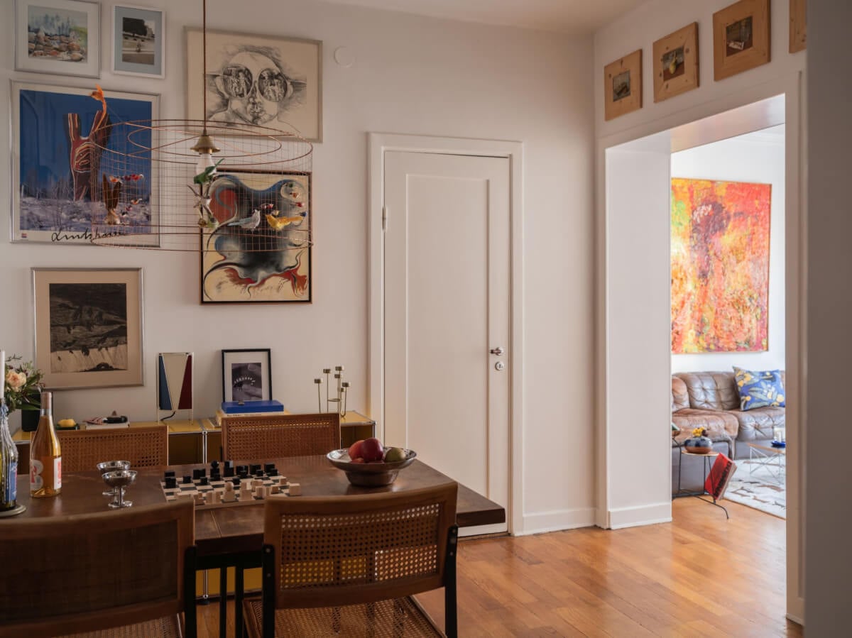 An Airy One-Bedroom Apartment with Art and A Yellow Kitchen 12 dining room art filled